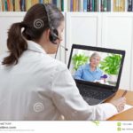 doctor-geriatrics-her-surgery-office-headset-front-laptop-video-call-senior-patient-prescribed-drugs-113142455